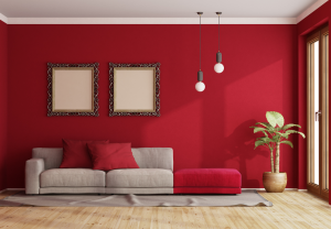 modern living room with red walls and tan and red couch