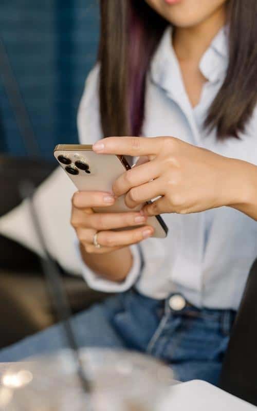 woman looking at her phone learning about niche investor team