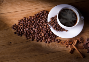 coffee beans around coffee in mug