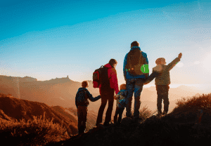 family hiking at with backpacks